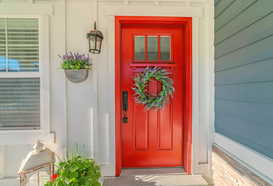 Red door with wreath of lavender flowers